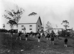 Children playing games outside a school, Kaitaia