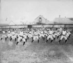 Wellington Physical Training School. Men doing stretches.