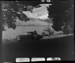 Unidentified man [Harry Wigley?] with a Chevrolet sedan car beside Lake Ohau, Waitaki County