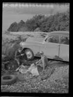 Harry Wigley and Leo Lemuel White having a picnic beside a Chevrolet sedan car at Lake Ohau, Waitaki County