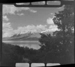 Lake Ohau, Central Otago, view across lake through trees to snow covered Ben Ohau Range beyond