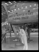 Mr S R Jones, working on a Rolls-Royce Dart Turbo prop aircraft engine during the 1953 London-Christchurch Air Race, Harewood Airport, Christchurch