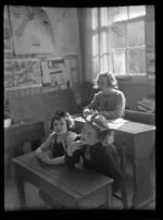 Children from Weheka School sitting at desks, West Coast Region