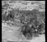 Red Beach, Rodney District, Auckland, showing houses, pine trees and cliff face