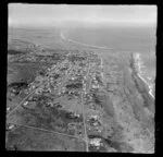 Castlecliff, Wanganui, aerial view along southern coastline showing houses with Cornfoot Street and Karaka Street with beach