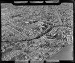 An aerial view of Avonside Girls' High School and Wilding Park in the background, including Avon River in the foreground, Christchurch