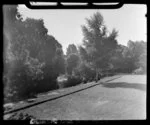 Unidentified group of people sitting alongside Avon River, Christchurch