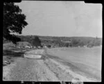 Matakatia, Whangaparaoa Peninsula, showing houses and dinghy on the beach