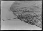 View over the New Zealand Refrigerating Company, Imlay Freezing Works Imlay Place, Wanganui, with stock pens and yards, showing Heads Road, Balgownie Avenue surrounded by residential housing, located beside the Wanganui River with wharf for loading ships