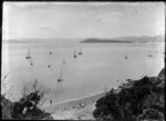 Lowry Bay, Eastbourne, Lower Hutt, showing swimmers and yachts in harbour, with Somes Island in distance
