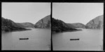 Two people in a rowing boat on a lake or inlet,[Catlins?]