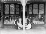 Employees outside the confectionery shop of W S Dustin, Wanganui