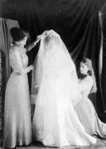Woman in a bridal gown and veil, with Phyllis Fell