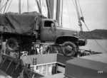 Army truck being hoisted out of a ship, Pacific area