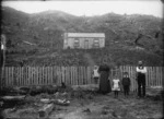 The Reid family outside their slab hut home, Whangamomona