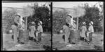Richard L Williams at incinerator in garden with children Edgar Richard Williams, Edith Kenworth, and Owen William Williams, looking on [Motohou Station, Brunswick, Whanganui Region?]