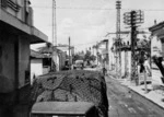 Army trucks driving through a street in Larissa, Greece