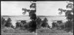 Unidentified men sitting in paddock [coastal area? lake?], Catlins area, Clutha District, Otago Region