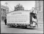 Tram decorated with World War 1 propaganda, including an unidentified tram conductor, Cathedral Square, Christchurch