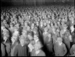 Crowd gathered in Cathedral Square, Christchurch, to view the parliamentary general election results displayed on a hoarding attached to the Christchurch Press building