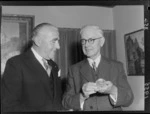 Professor Charles Andrew Cotton (on left) being presented with the Andre Dumont Medal of the Geological Society of Belgium by an unidentided man, Council Room, Victoria University, Wellington