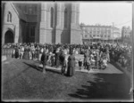Crowds of people gather in front of the Cathedral Church, Cathedral Square, Christchurch