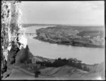 A view of Whanganui township and river, with ships docked along the shoreline