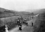 Group on carriages pulled by a traction engine, and cyclists, in Blenheim