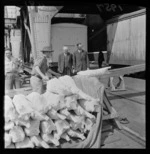 The Hon R G Gerard (Minister of Marine) with Sir William Appleton and sheep carcases being loaded on railway vans