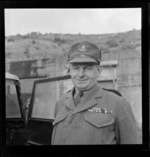 Man in a military uniform standing next to a jeep at the Army Fort on Wrights Hill, Karori, Wellington