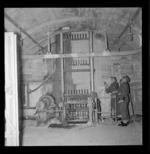 Two men in military uniform checking the generator for power at the Army Fort on Wrights Hill, Karori, Wellington