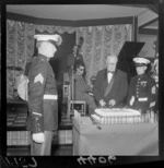 The American Ambassador (Francis H Russell) cutting the cake at the anniversary of the United States Marine Corps