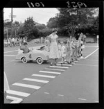 Traffic training, Karori School, Wellington, children learning to stop at a pedestrian crossing to allow people to cross the road safely