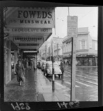 Manners Street looking toward Cuba Street, with signs for Fowlds for Menswear, The Chocolate Box, Emabassy Restaurant, and Radfords Furniture across the road, Wellington