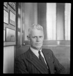 Portrait of Ernie West of Middle District Aero Club, at Whites Aviation Office, Auckland