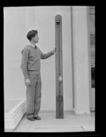 Unidentified man with a light panel relic from the American Airways Sikorsky flying boat 'Samoan Clipper',  at Musick Point Air Radio Station, Howick,  Auckland