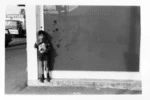 boy in front of shop window 1970.tif