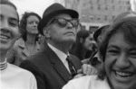 Soldiers' return . Man with shades&trilby&crowd.tif