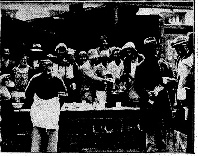 Image: FEEDING THE HUNGRY AT HASTINGS.—GirIs and young men working in front of ajem/prmft. kitchen at Hastings. Soup and coffee are.served freetorfyugett^nd-helperf&ttkirhtwmk, ' J (Evening Post, 10 February 1931)