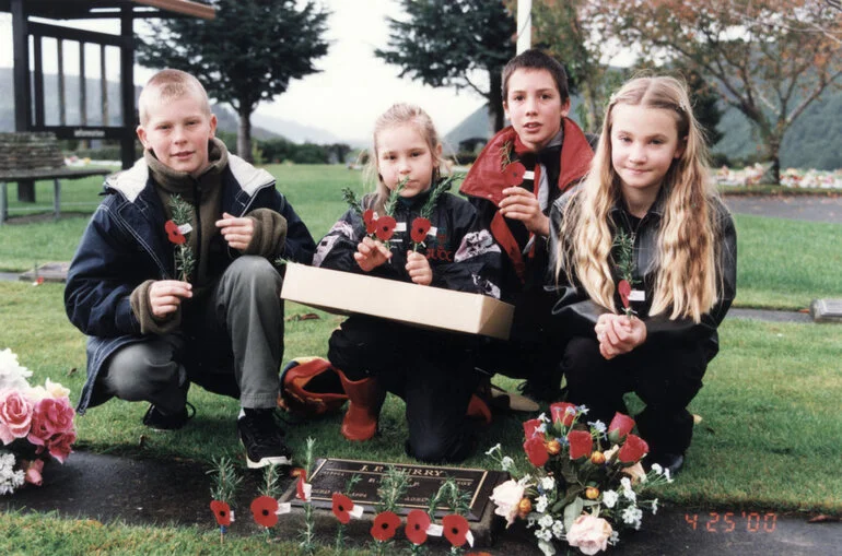 Image: Anzac Day; Nelson, Morgan and Daniel Curry and Kate Sinai at the grave of their grandfather, Jim Curry