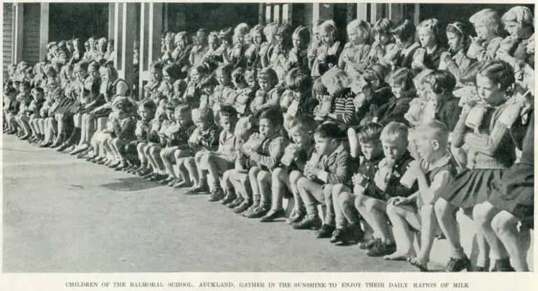 Image: Children of the Balmoral School, Auckland, gather in the sunshine to enjoy their daily ration of milk