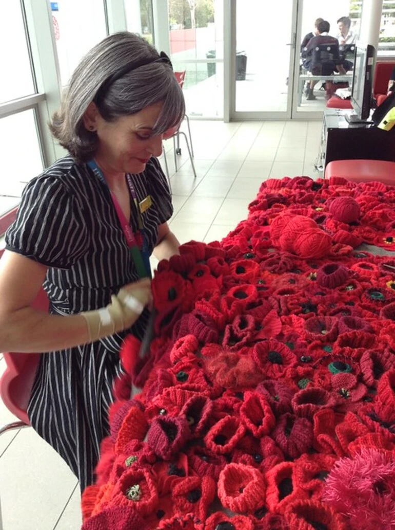 Image: Catherine sewing the poppies