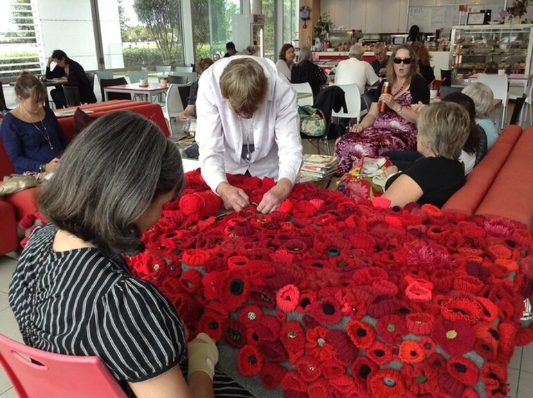 Image: Sewing the poppies onto the blanket