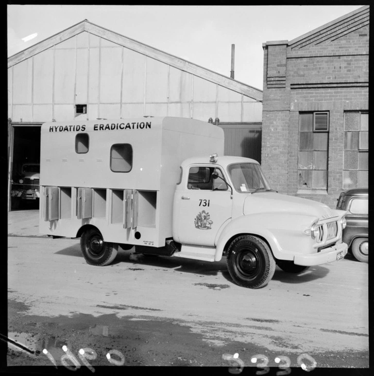 Image: A Wellington City Council Hydatids Eradication Bedford van with external dog cage compartments on a unknown street, probably Wellington City