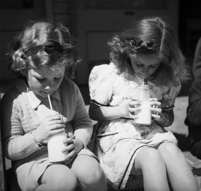 Image: Two primary school girls drinking their school milk, Linwood, Christchurch