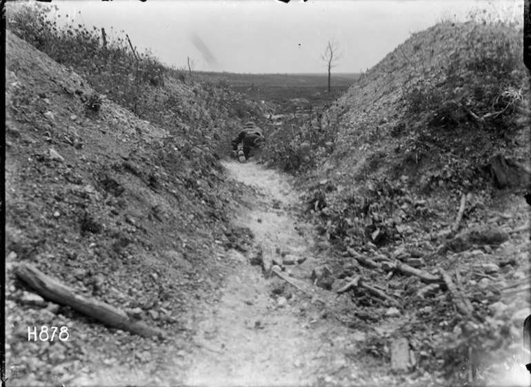 Image: A runner moving through a front line trench in World War I