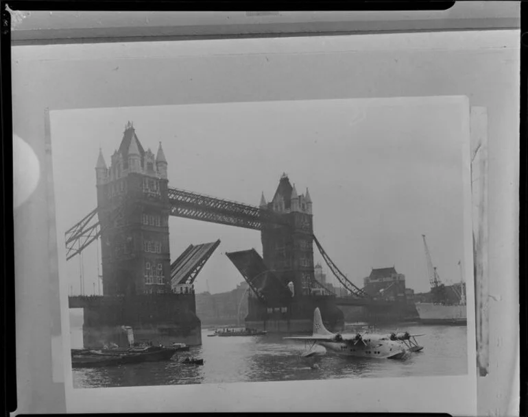 Image: Tower Bridge, London, with the bridge raised and a seaplane in the water nearby