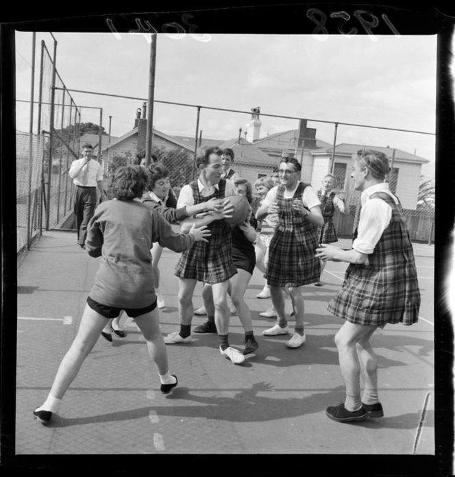 Men dressed in gym slips playing netball against women, Department of Health, Wellington