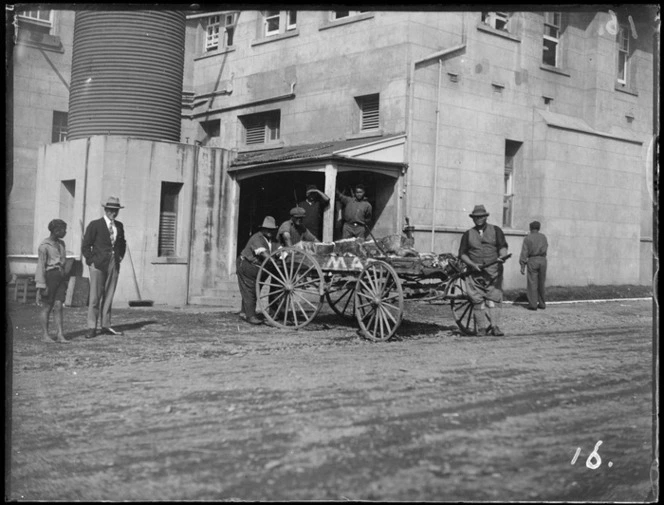 Group of men stand by cart, probably Hastings district