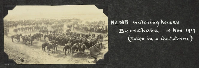 Soldiers of the New Zealand mounted Rifles watering horses in a dust storm